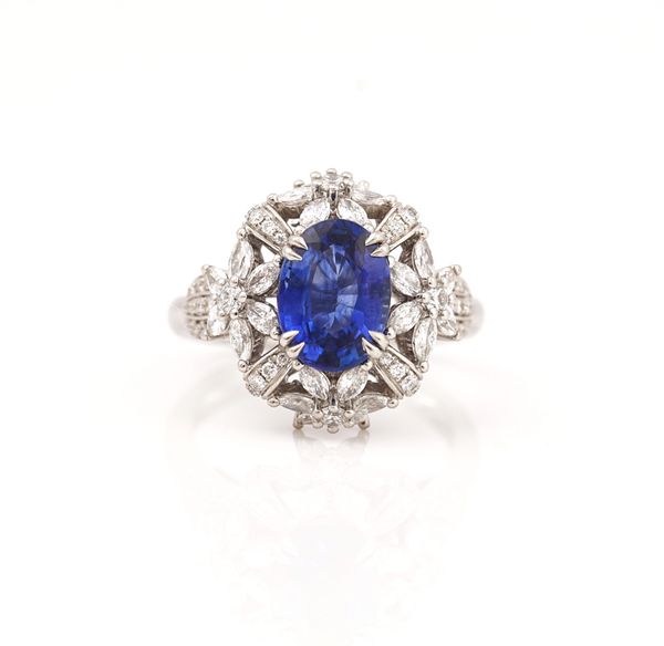 A platinum, sapphire and diamond set  oval cluster ring