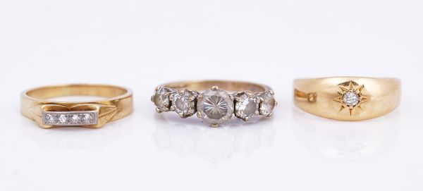 A gold and platinum, diamond set four stone ring and two further rings (3)