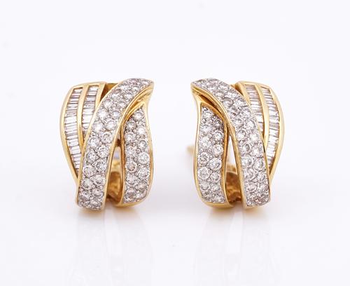 A pair of gold and diamond earclips