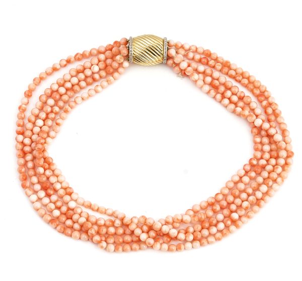 A coral necklace with a gold and diamond clasp