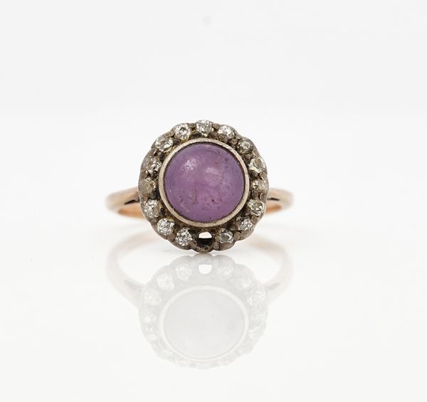 A cabochon pale lilac coloured sapphire and diamond cluster ring