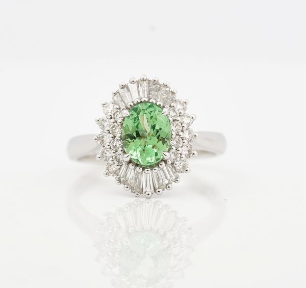 An 18ct white gold tsavorite and diamond set oval cluster ring