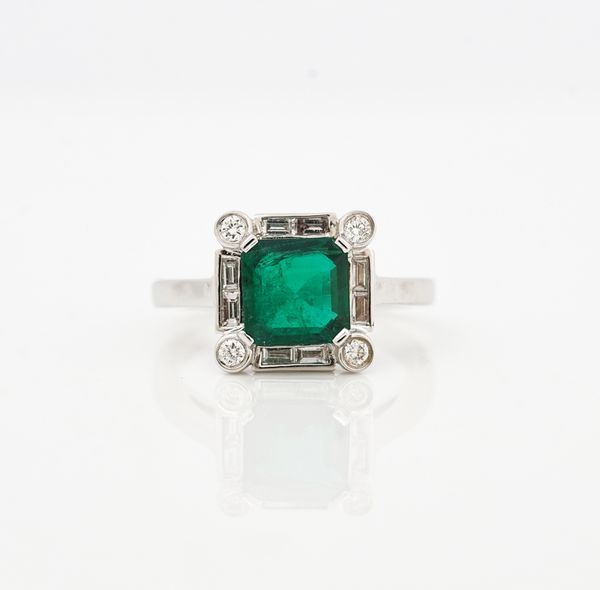 An 18ct white, gold emerald and diamond square ring