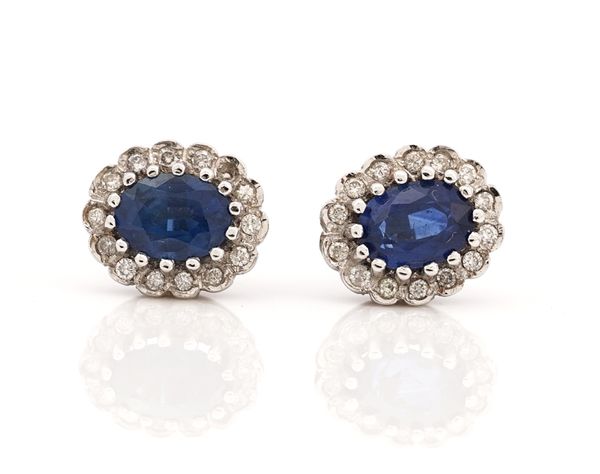 A pair of 18ct white gold, sapphire and diamond oval cluster earstuds