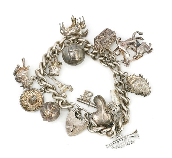 A silver curb link charm bracelet, with a silver heart shaped padlock clasp