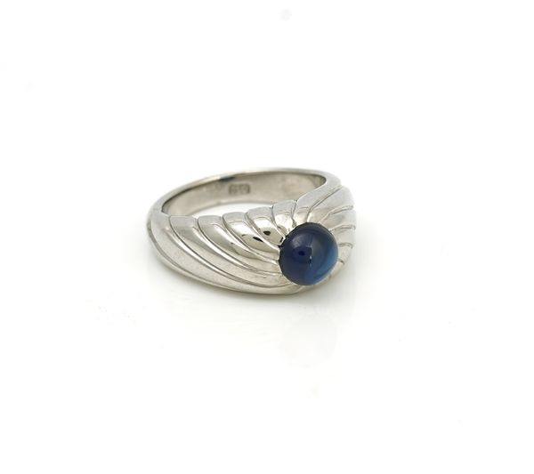 A white gold and cabochon sapphire single stone ring