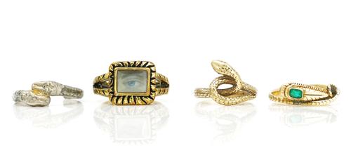 An emerald set ring in the form of a wrythen snake and three further rings (4)