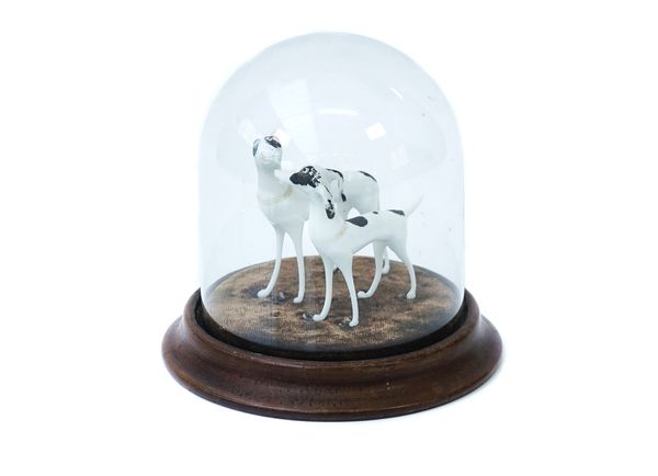 AN OPAQUE MODEL OF TWO DOGS UNDER A GLASS DOME