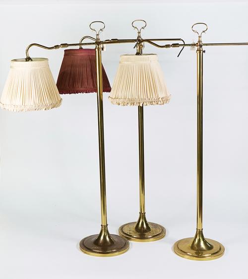 A SET OF THREE BRASS ADJUSTABLE FLOOR STANDING READING LIGHTS