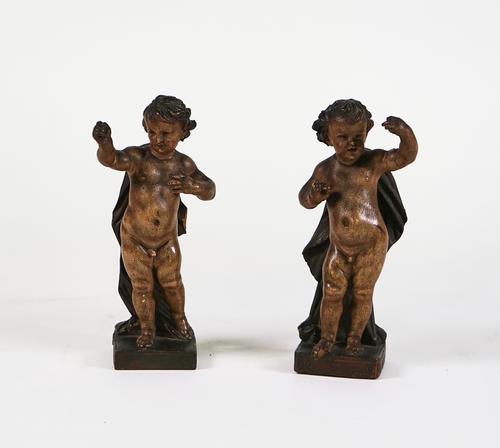 A PAIR OF SOUTH GERMAN OR  NORTH ITALIAN PAINTED PUTTI (2)