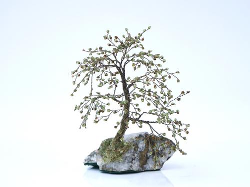 A green gem set and wirework ornamental tree