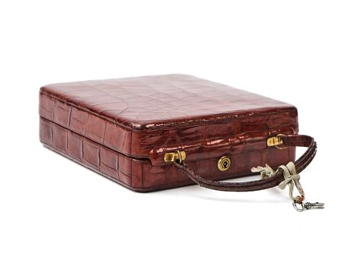 A CROCODILE LEATHER TRAVELLING VANITY/JEWELLERY CASE