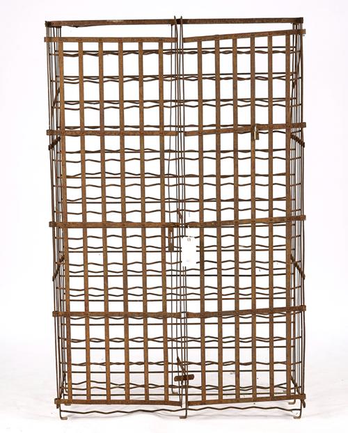 A LARGE WROUGHT IRON GATED WINE RACK