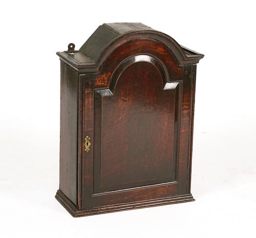 A GEORGE I JOINED OAK BONNET TOPPED HANGING SPICE CUPBOARD