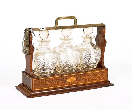 AN EARLY 20TH CENTURY INLAID OAK THREE BOTTE TANTALUS