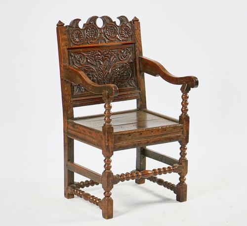 A CHARLES II JOINED OAK OPEN ARMCHAIR