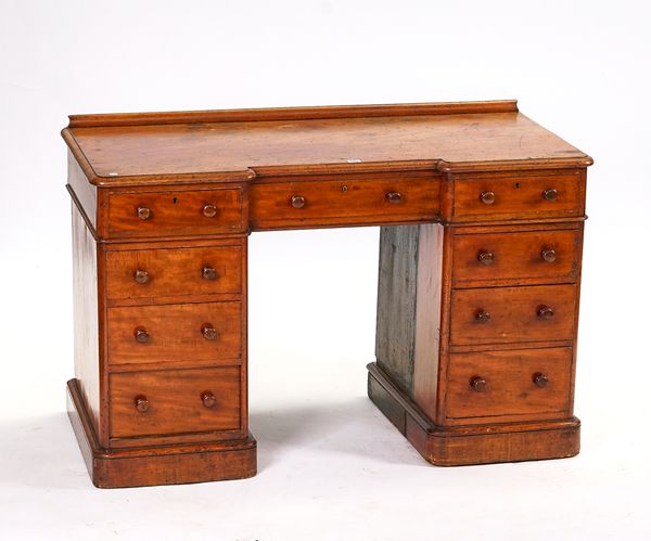 ‘HEAL & SON, LONDON’; A MAHOGANY INVERTED BREAKFRONT NINE DRAWER WRITING DESK