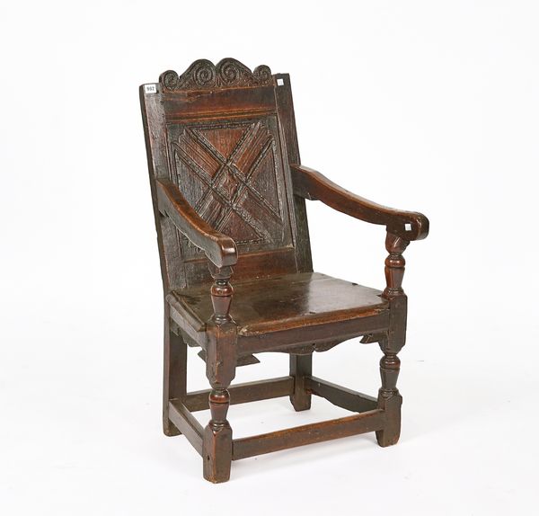 A CHARLES I JOINED OAK PANEL-BACK OPEN ARMCHAIR