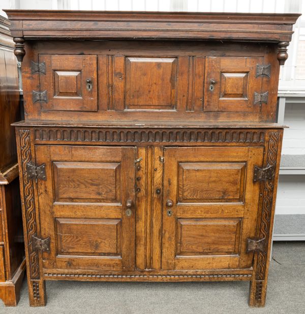 A 17TH CENTURY CARVED OAK COURT CUPBOARD