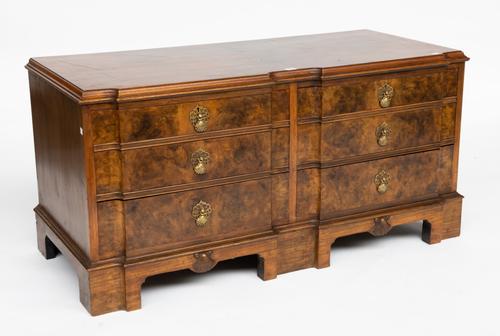 A LOW FIGURED WALNUT SHAPED SIX DRAWER CHEST