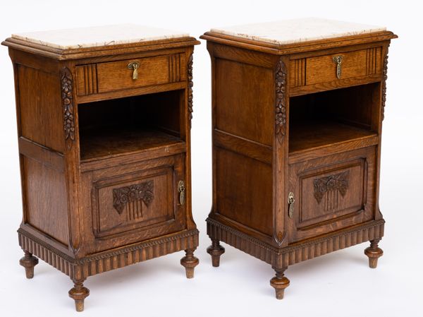 A PAIR OF MARBLE TOPPED CARVED OAK BEDSIDE TABLES (2)