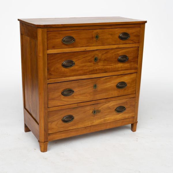 A 19TH CENTURY FRENCH FRUITWOOD FOUR DRAWER CHEST