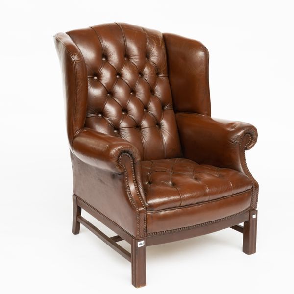 A GEORGE II STYLE STUDDED TAN LEATHER UPHOLSTERED WINGBACK ARMCHAIR