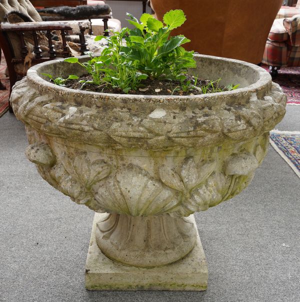 A RECONSTITUTED STONE JARDINIERE WITH FLORAL MOULDED BODY