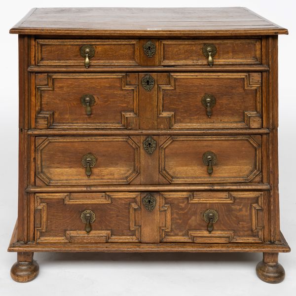 A CHARLES II GEOMETRIC MOULDED OAK TWO PART CHEST