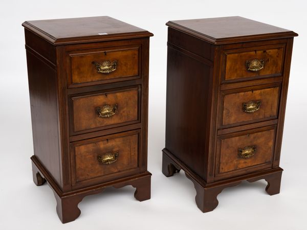 A PAIR OF WALNUT THREE DRAWER BEDSIDE TABLES (2)