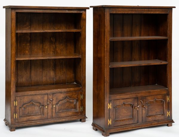 A NEAR PAIR OF OAK BOOK CASES WITH ADJUSTABLE SHELVES (2)