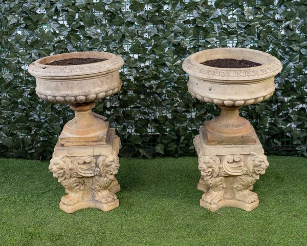 DOULTON AND CO; A PAIR OF TERRACOTTA JARDINIERES ON OPPOSING LION STAND (2)