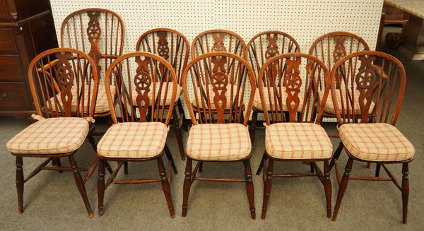 A MATCHED SET OF TEN BEECH AND ELM WHEEL BACK WINDSOR CHAIRS TO INCLUDE A PAIR OF YEW BACKED CARVERS (10)