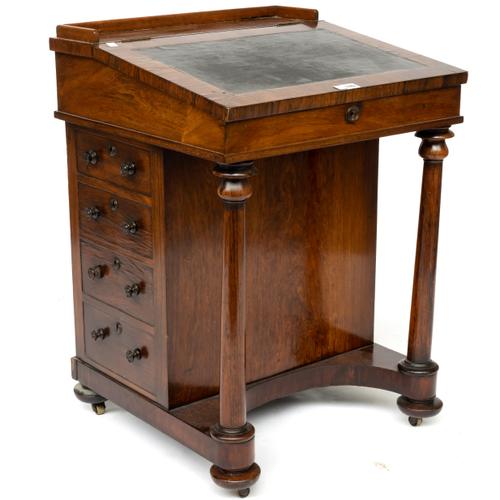 A REGENCY ROSEWOOD DAVENPORT WITH TURNED SUPPORTS