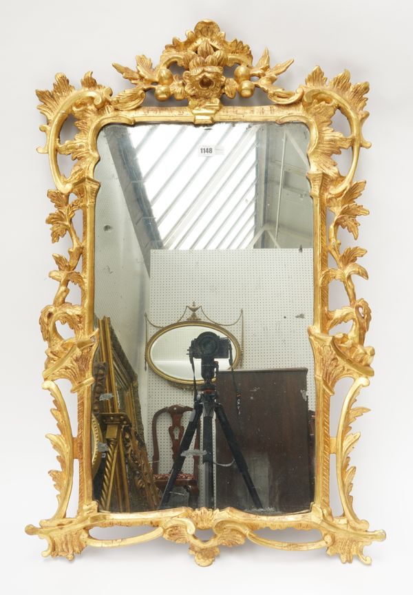 A GEORGE III GILT FRAMED MIRROR WITH PIERCED AND CARVED FLORAL CHASED FRAMED