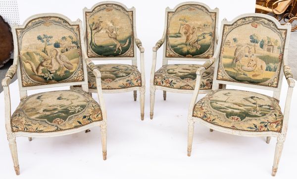 A SET OF FOUR LOUIS XVI STYLE GREY PAINTED HUMP BACK OPEN ARMCHAIRS (4)