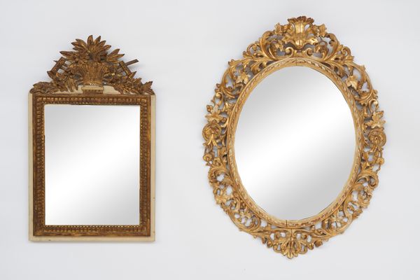 A 19TH CENTURY FLORAL CHASED GILT FRAMED OVAL MIRROR (2)