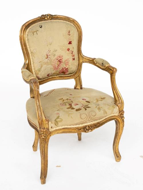 A 19TH CENTURY FRENCH GILT FRAMED CHILD’S OPEN ARMCHAIR OF 18TH CENTURY DESIGN