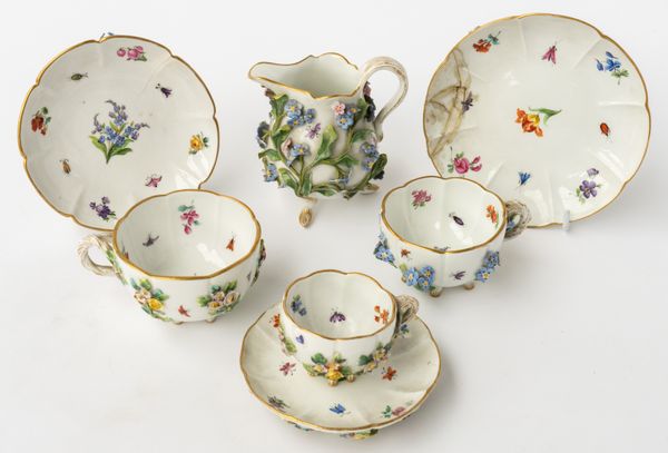 A MEISSEN FLOWER ENCRUSTED MILK JUG, THREE CUPS AND SAUCERS (7)