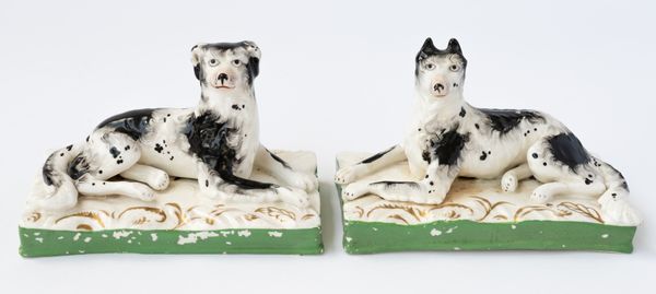 AN UNUSUAL PAIR OF STAFFORDSHIRE PORCELAIN WORKING DOGS (2)