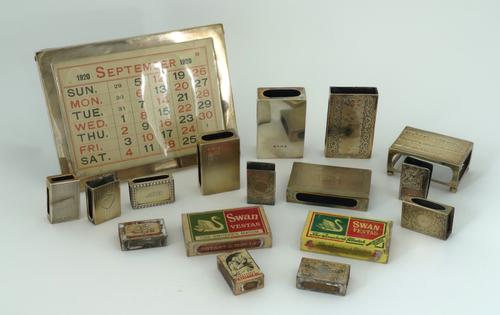 A SILVER MOUNTED DESK CALENDAR AND ELEVEN MATCHBOX SLEEVES (12)