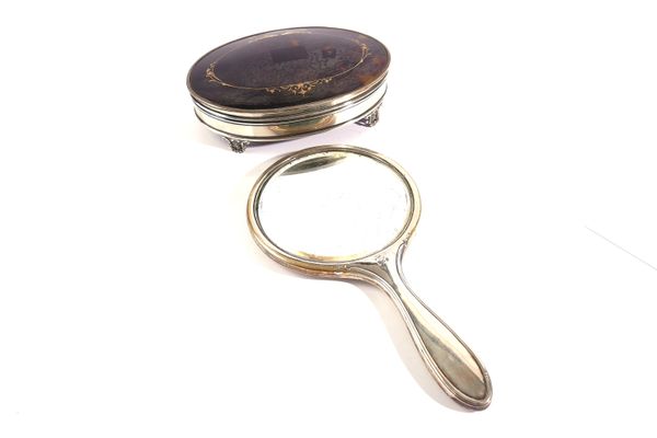 A SILVER AND TORTOISESHELL OVAL MANICURE CASE AND A SILVER MOUNTED HAND MIRROR (2)