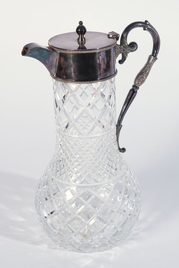 A SILVER MOUNTED MOULDED FACETED GLASS CLARET JUG