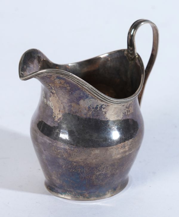 A GEORGE III SILVER CREAM JUG