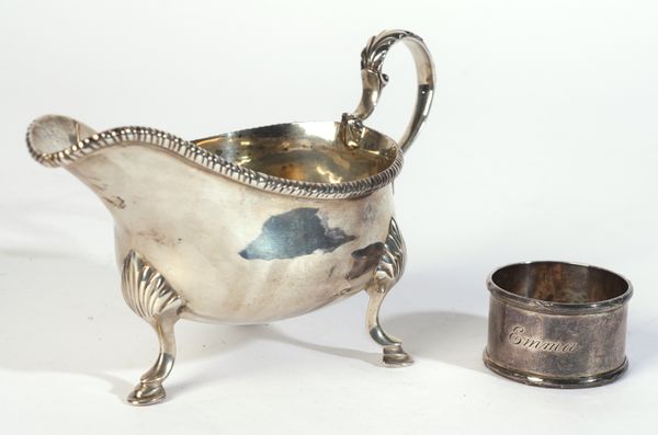 A SILVER SAUCEBOAT AND A SILVER NAPKIN RING (2)