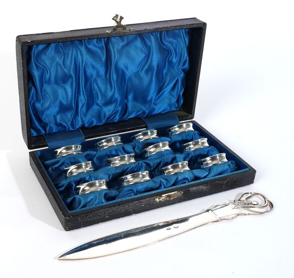 A DANISH PAPER KNIFE AND A SET OF TWELVE SMALL FOREIGN NAPKIN RINGS (2)