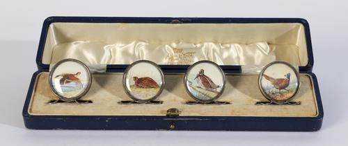 A SET OF FOUR EDWARDIAN SILVER MOUNTED 'GAME BIRD' MENU HOLDERS (4)