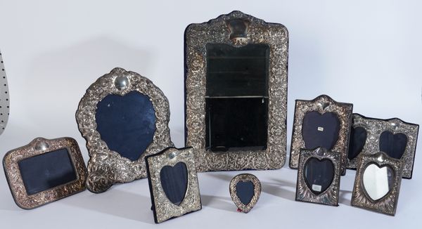 A SILVER MOUNTED MIRROR AND EIGHT PHOTOGRAPH FRAMES (9)