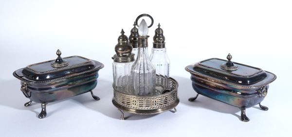 A GEORGE III SILVER CRUET STAND AND A PAIR OF PLATED ON COPPER TUREENS AND COVERS (3)