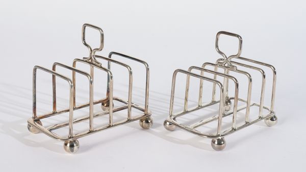 A PAIR OF SILVER FIVE BAR TOASTRACKS (2)